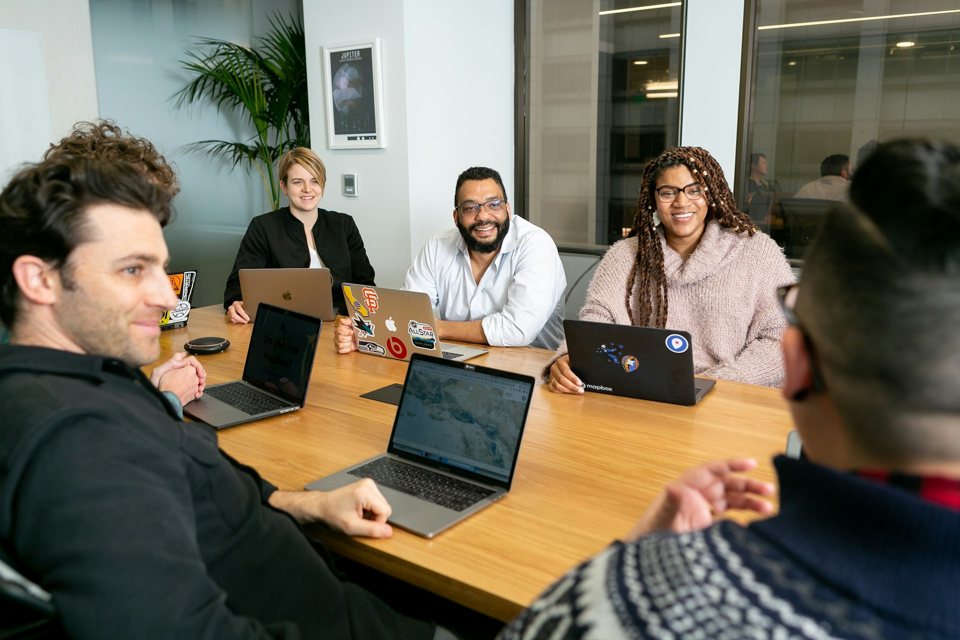Friendly consultant smiling on the phone at a modern open-plan office desk